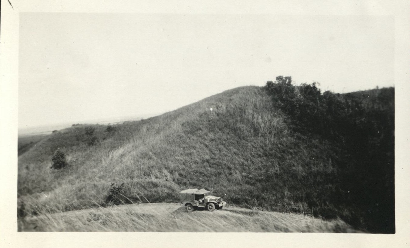 [Untitled – U.S. army jeep on a grassy hill, probably in Pampanga].