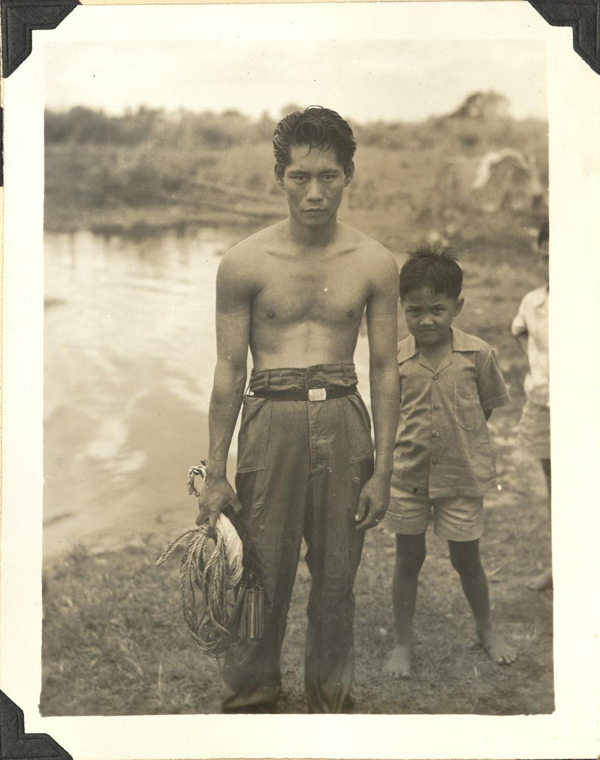 [Untitled – Shirtless man cools off in a river].