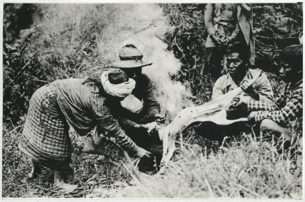 [Indigenous people skinning a dog].