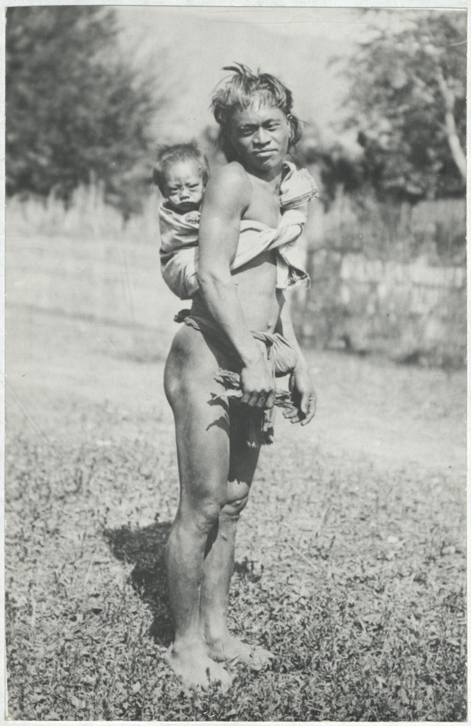 [Untitled – Indigenous man carrying baby on his back].