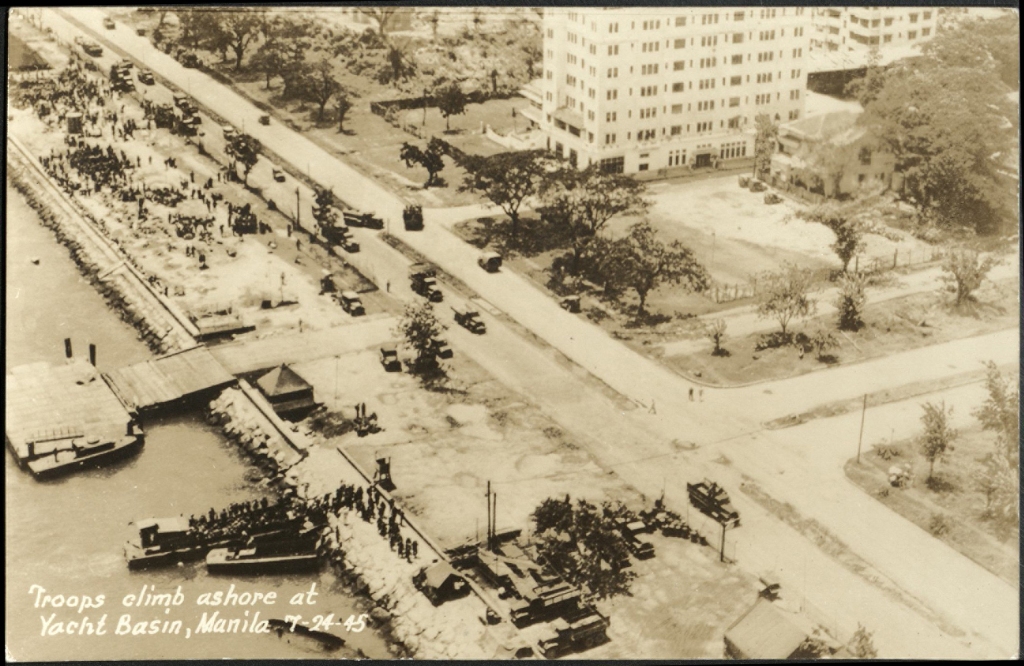 Troops climb ashore at Yacht Basin, Manila, 7-24-45.
