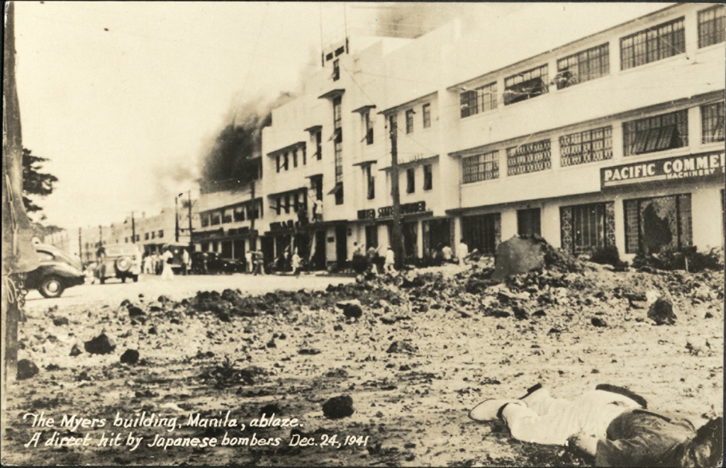The Myers building, Manila, ablaze. A direct hit by Japanese bombers Dec. 24, 1941.