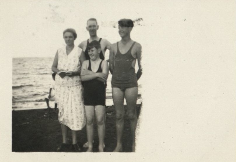 Mother [Hawkins], Dad [Harry Hawkins, Sr.], Bob [Hawkins], and Jim [Stapler] on the beach.