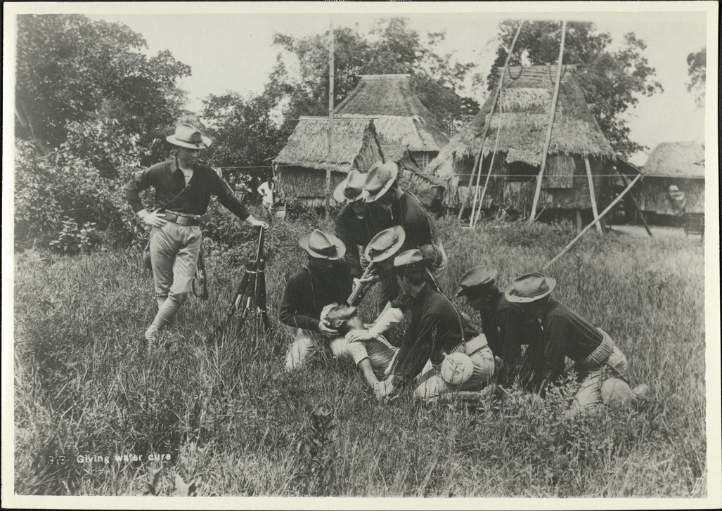 Giving water cure.