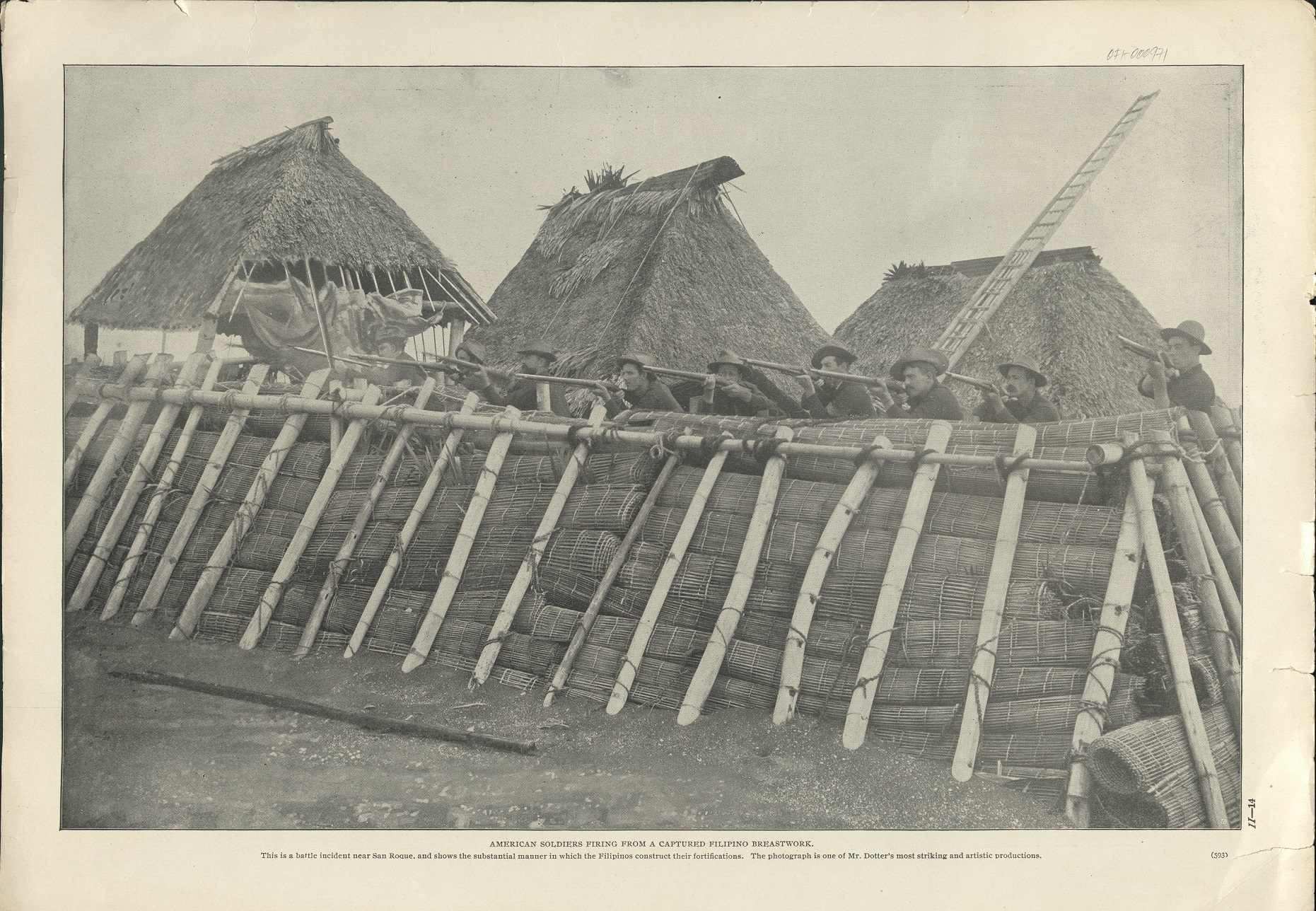 American soldiers firing from a captured Filipino breastwork. (…)