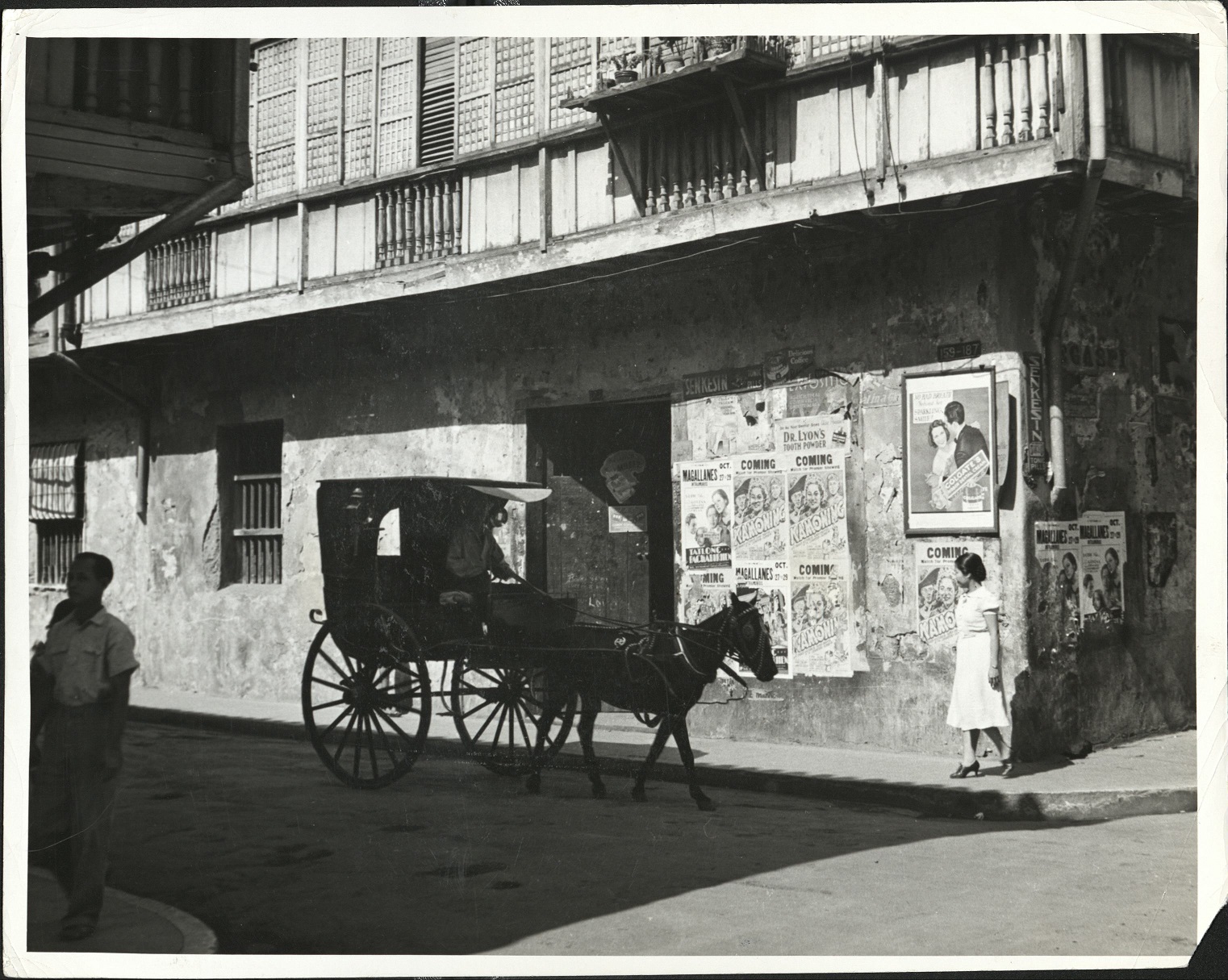162. PHILIPPINES: A “calesa” (horse-drawn gig) in one of the streets of Intramuros, in Manila. The poor ride in these vehicles which while brightly painted, are usually fragile, and pulled by thin horses.