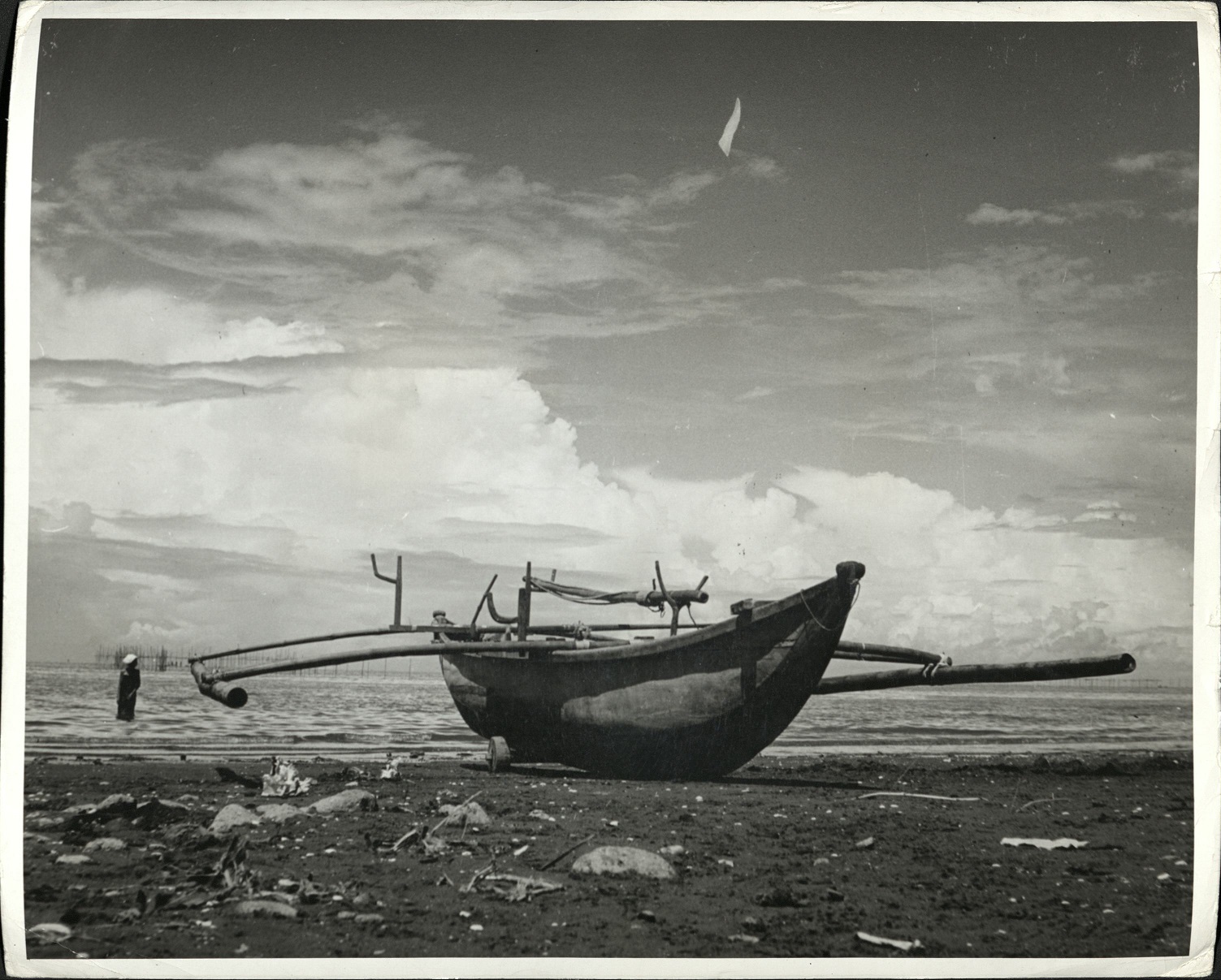 An outrigger native boat on the coast of Aparri, Northern Luzon, where Japanese invaders were mopped up and near where a Japanese battleship went down.
