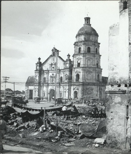 Activity in the Philippine capital goes on among the bombed ruins of the wrecked city [Binondo Church].