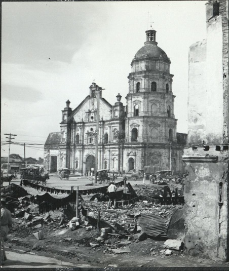Activity in the Philippine capital goes on among the bombed ruins of the wrecked city [Binondo Church].