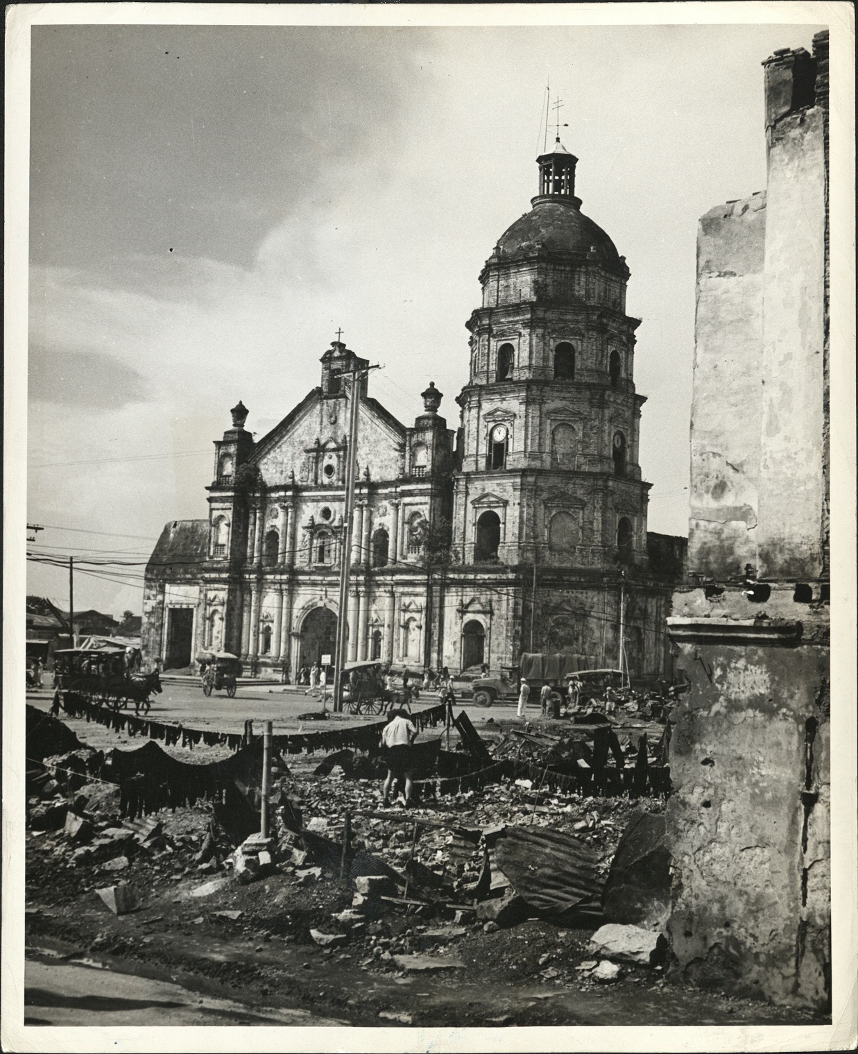 40. PHILIPPINES – Manila: Activity in the Philippine capital goes on among the bombed ruins of the wrecked city [Binondo church].  J-1441.