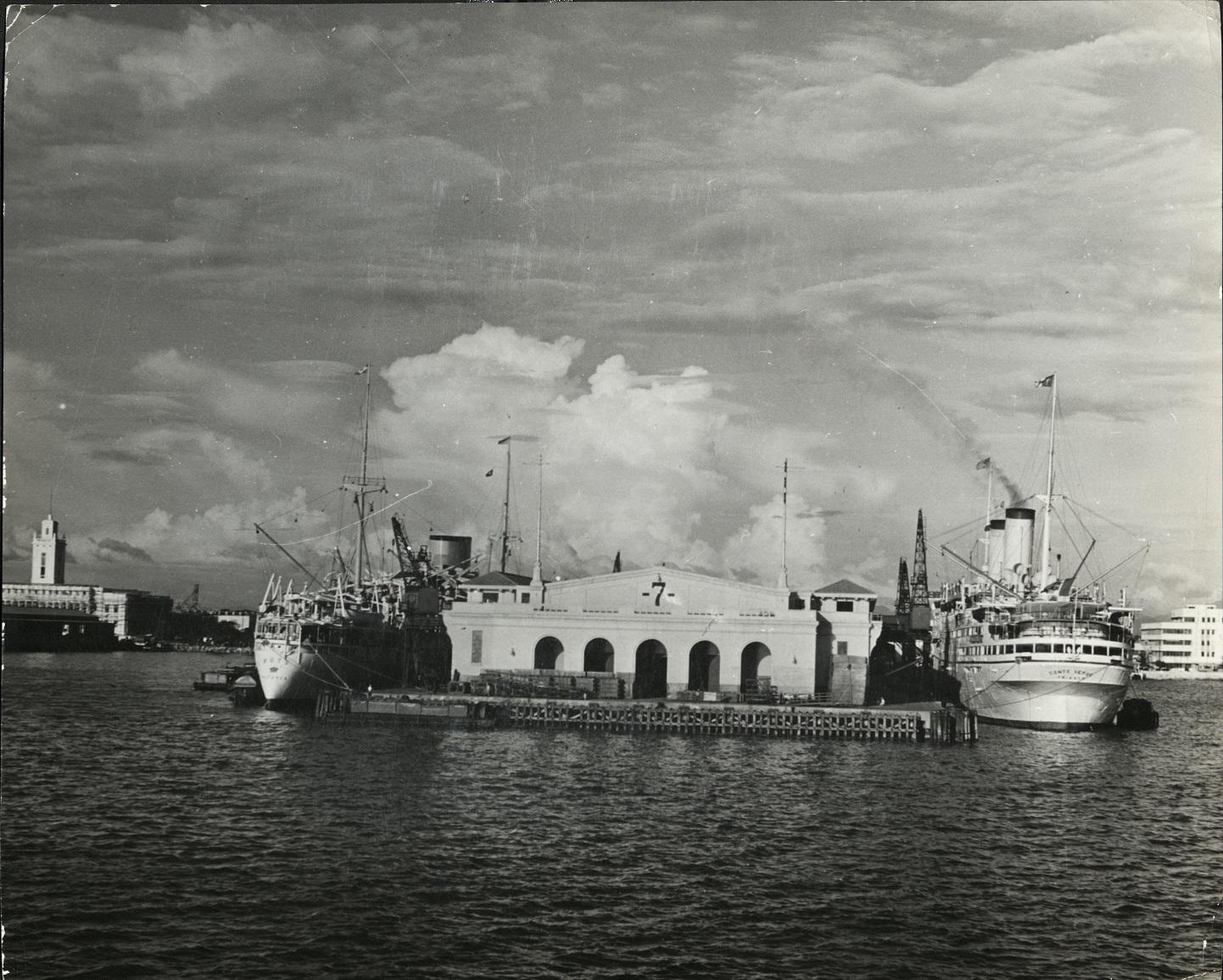 Liners tied up at the pier in Manila Harbor, where Japanese bombs are now falling almost incessantly.