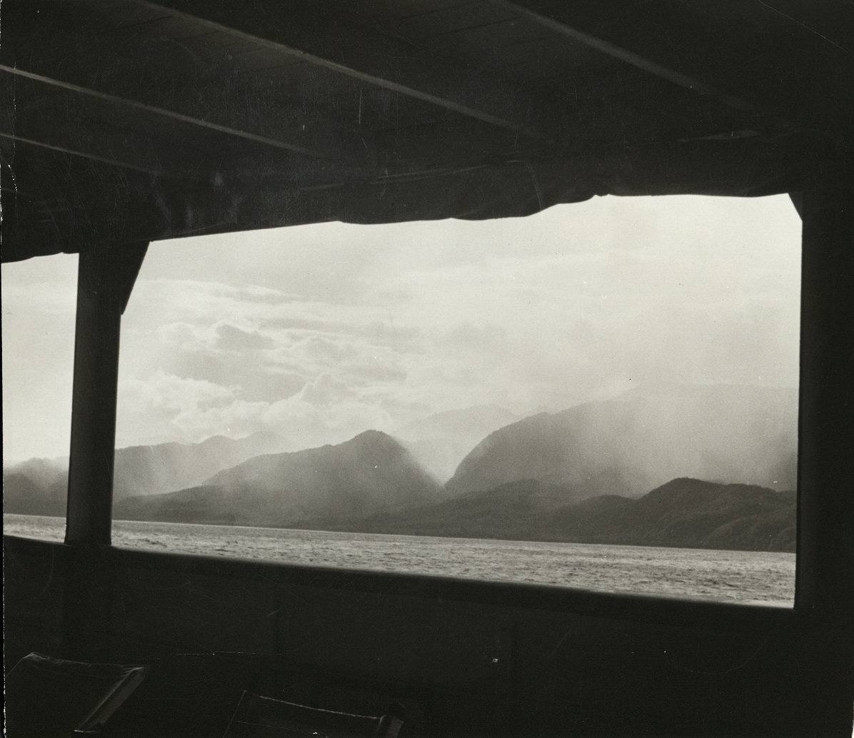 The coastline of Mindanao, Philippines, with rain falling in the hills.