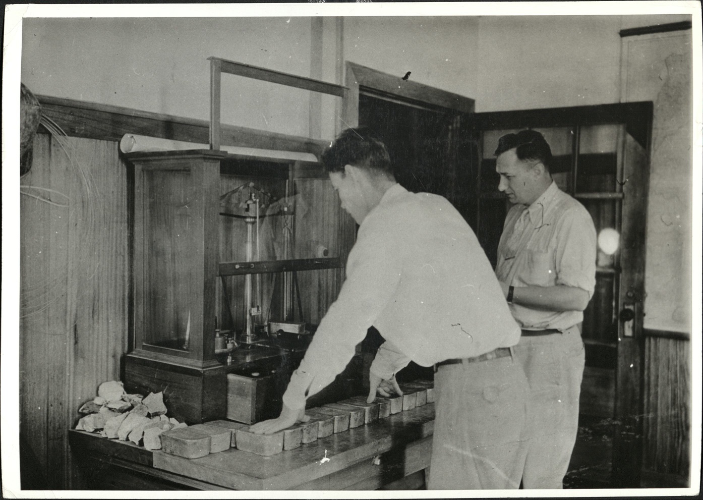 Weighing gold bullion at Benguet Consolidated, Philippines gold mines.