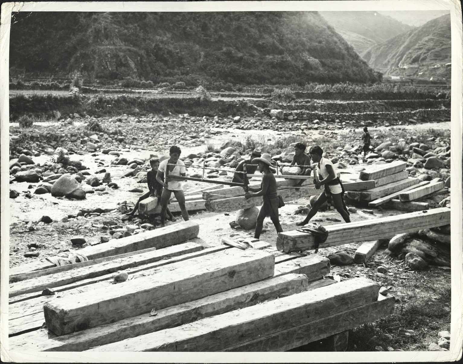 241. Philippines. A lumber shop set up in a beautiful mountainous region.