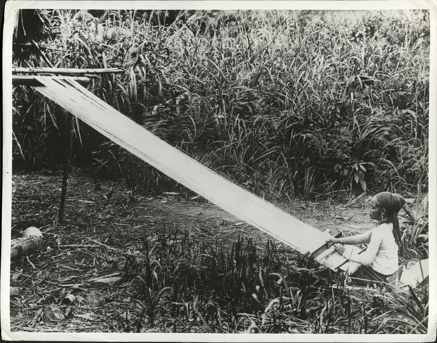 PHILIPPINES: Hemp drying process. E-276. [mislabeled – actually a Filipina weaving outdoors].