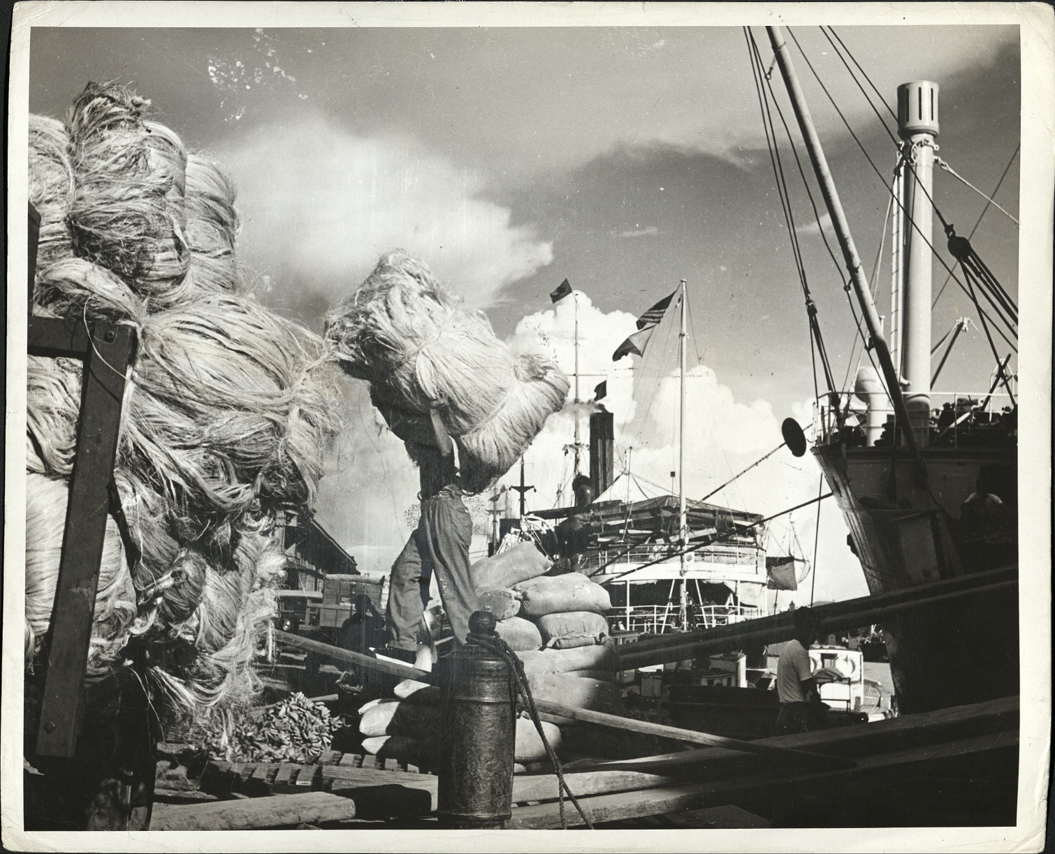 8. PHILIPPINES: Pasig River waterfront at Manila. Unloading hemp from an inter-island freighter.