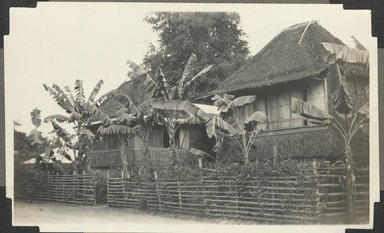 Native nipa house, split bamboo fence, and banana trees in the yard. Scene taken in Paranaque District, Manila, P. I.