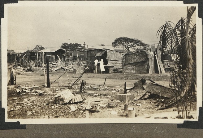 Refugees in front of lean-to. (Scenes on this page taken immediately after the fire which entirely devastated Pasay District and rendered many homeless).