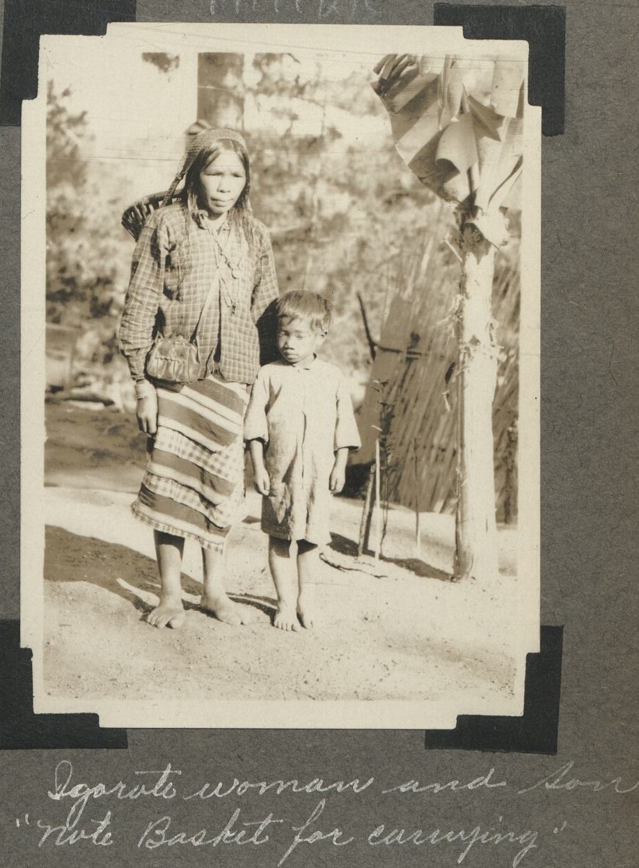 Igorot woman and son. “Note basket for carrying.”