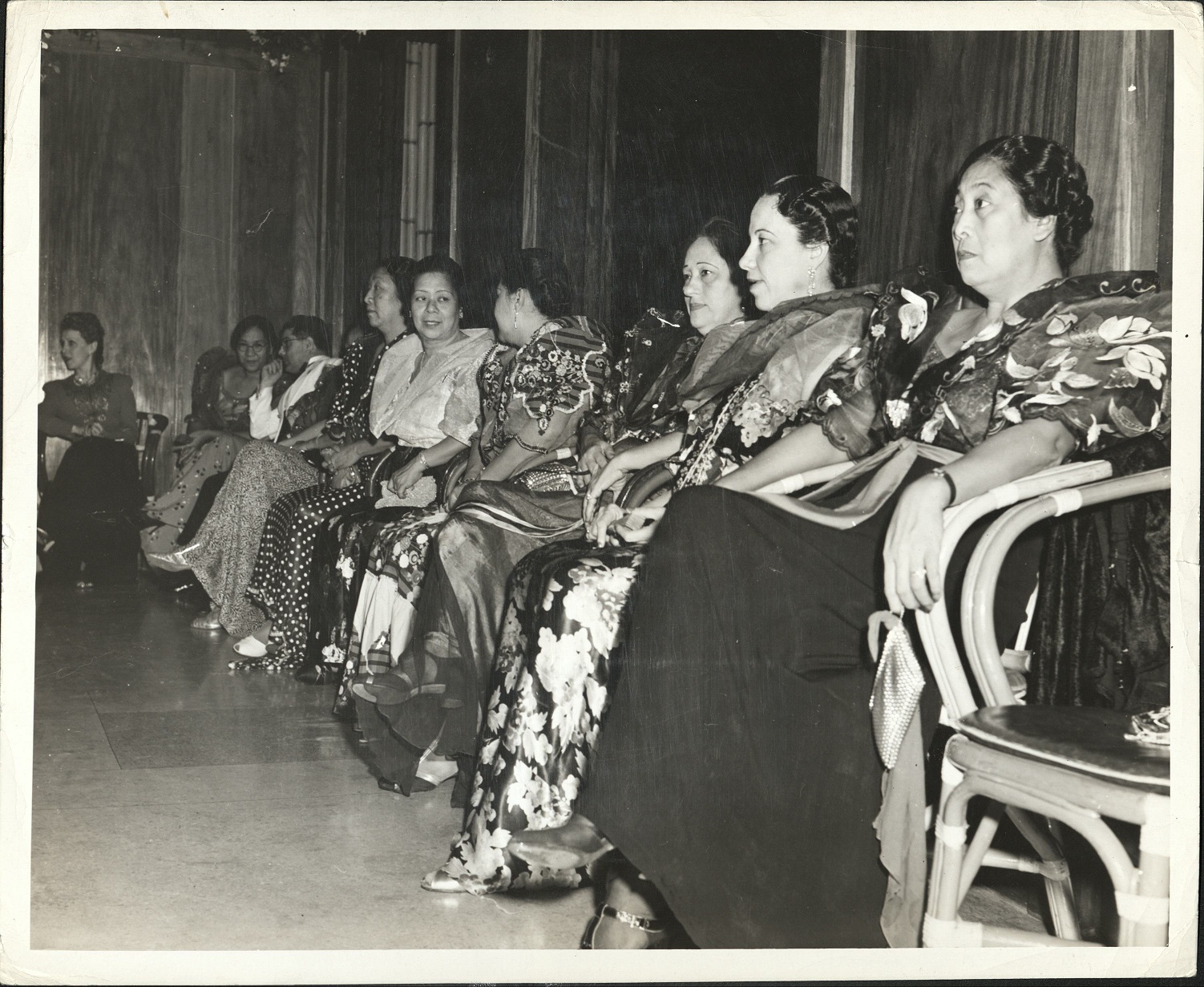 137. PHILIPPINES: Wealthy women wearing American clothes during the day, don native mestiza dress for evening parties like this one at Malacanang, presidential palace. (…)