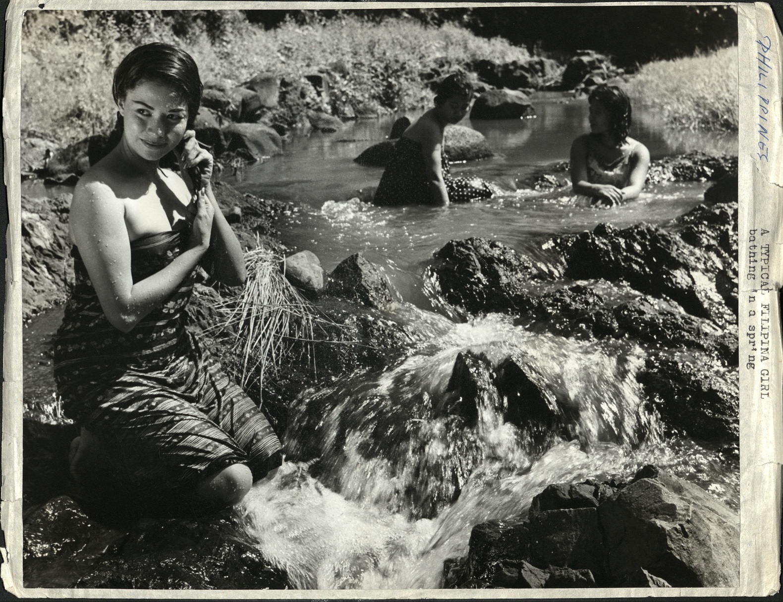 PHILIPPINES: A typical Filipina girl, bathing in a spring.