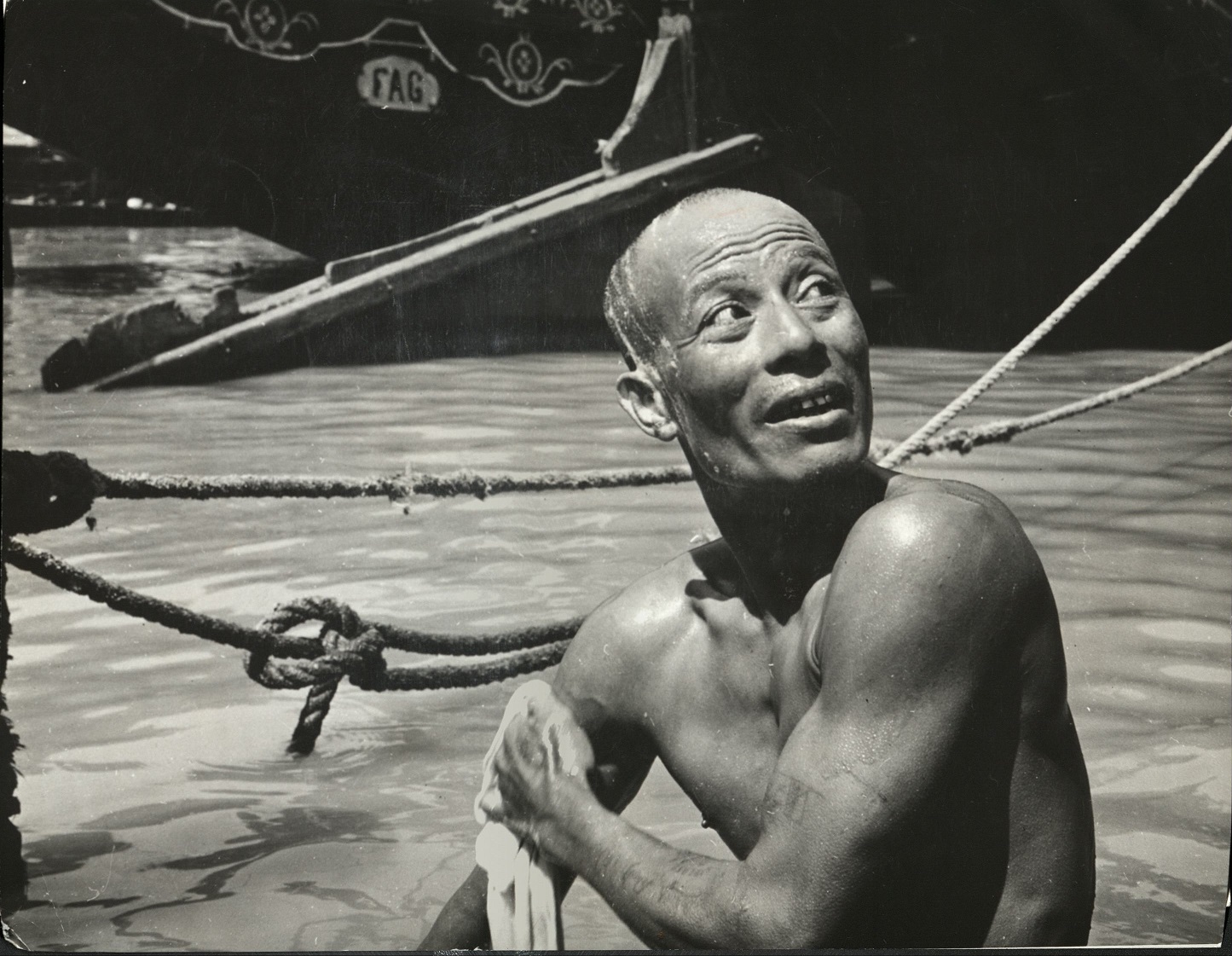 95. PHILIPPINES: Bathing in the Pasig River in Manila. Junks in background.