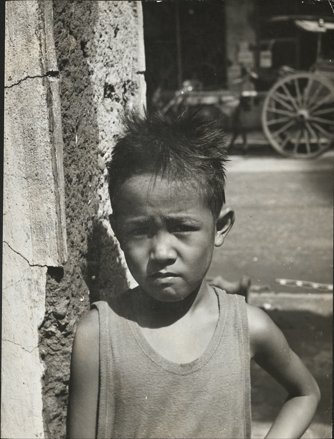 [Caption missing – young Filipino boy on the street].
