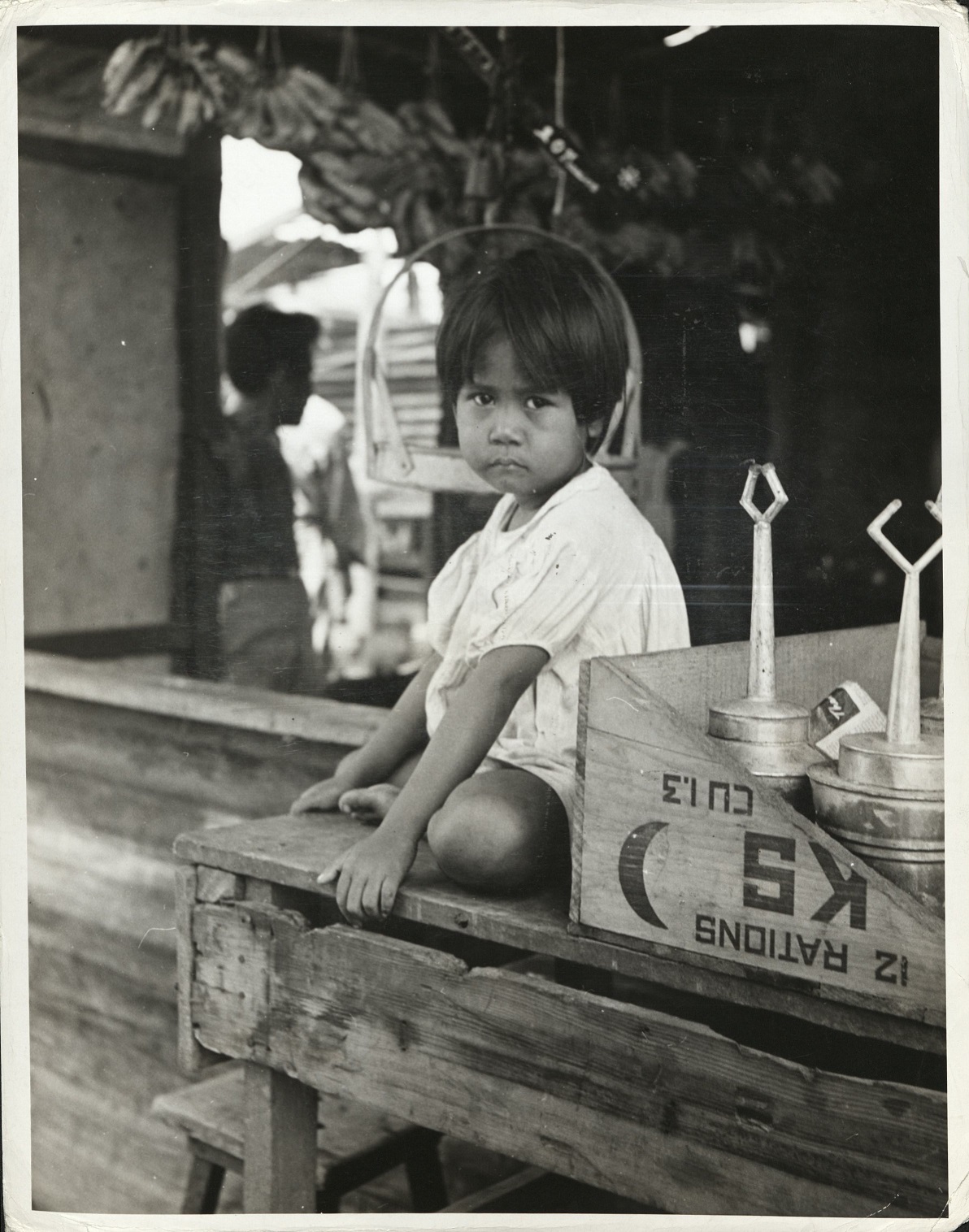 [Caption missing – Filipino boys sits on table top].