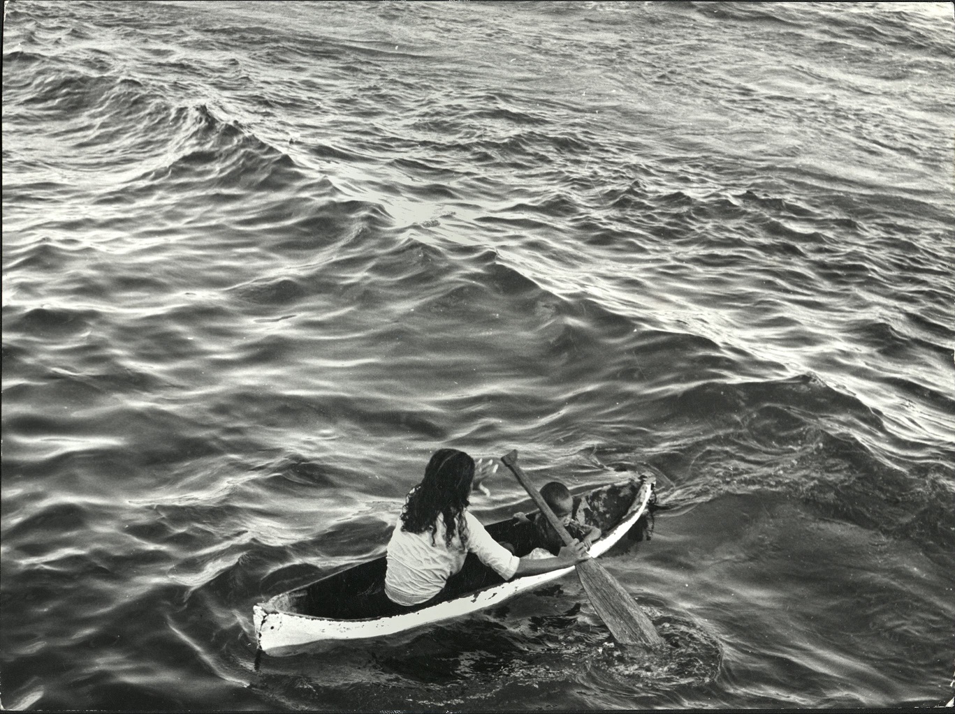 49. PHILIPPINES: Island of Mindanao. Mother with child in a small boat off Zamboanga.  Sammer 9980.
