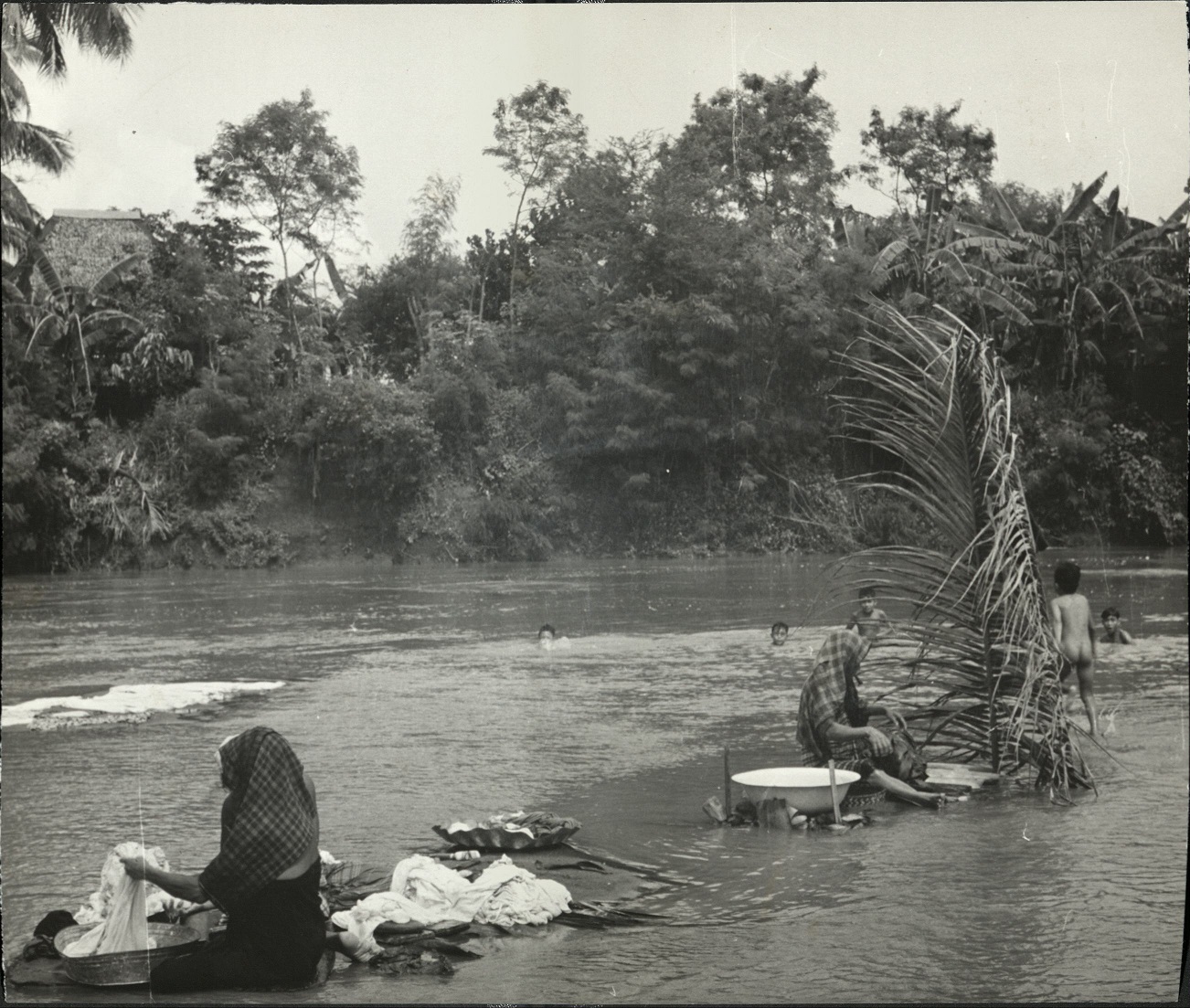Washing clothes on the river bank at Iloilo, Island of Panay, Philippines.