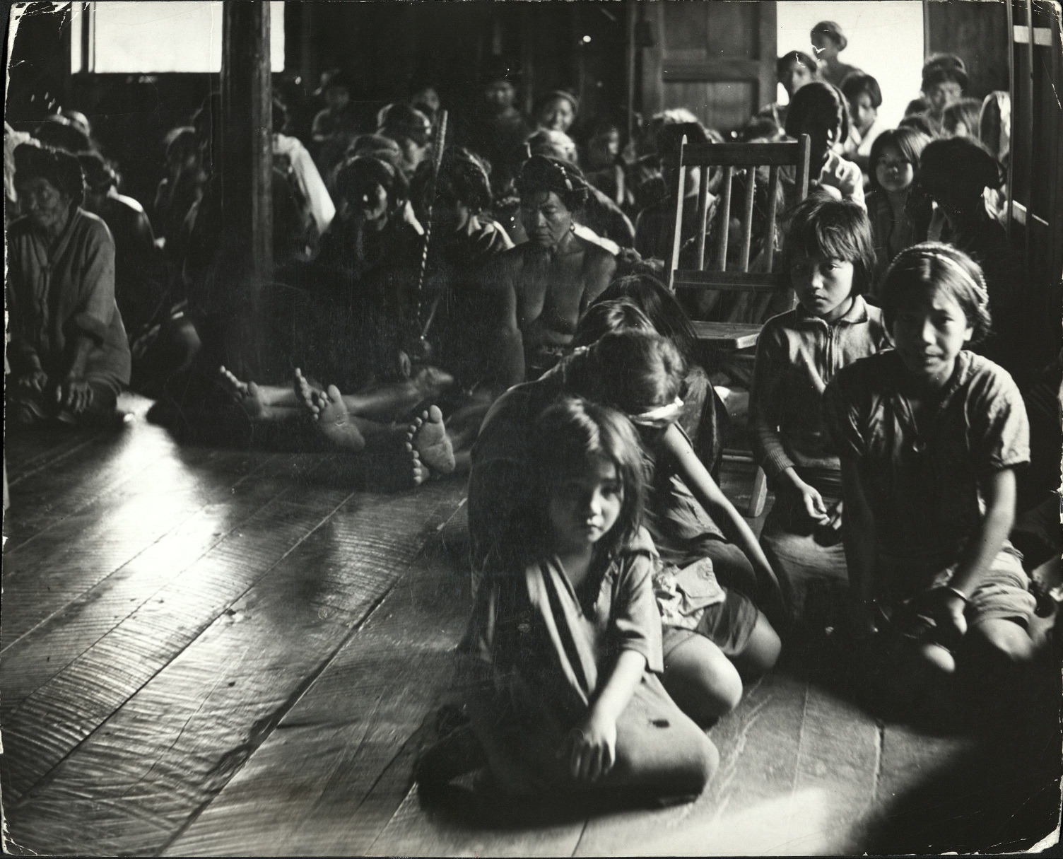 Filipinos attending service at a little village church in [a] Luzon province.