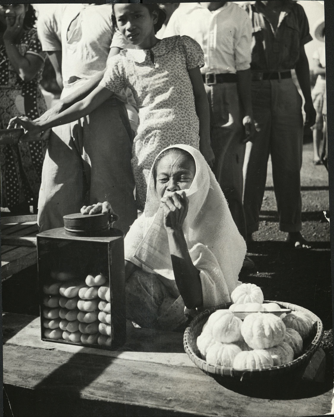 A street vendor on Cebu, Philippines, selling bits of fruit and bread to passengers on the inter-island ferry operating between Cebu and Negros.