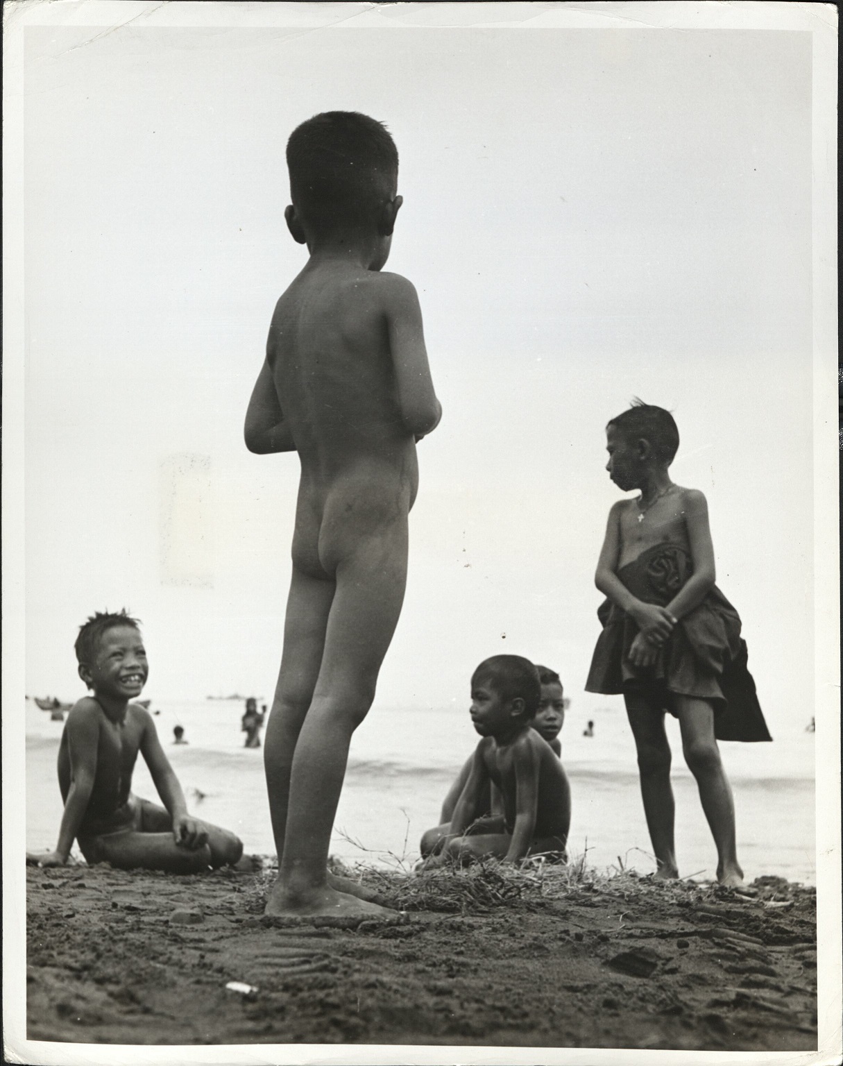 9. PHILIPPINES – Children. Manila children frolic along the beach.  J-1436.