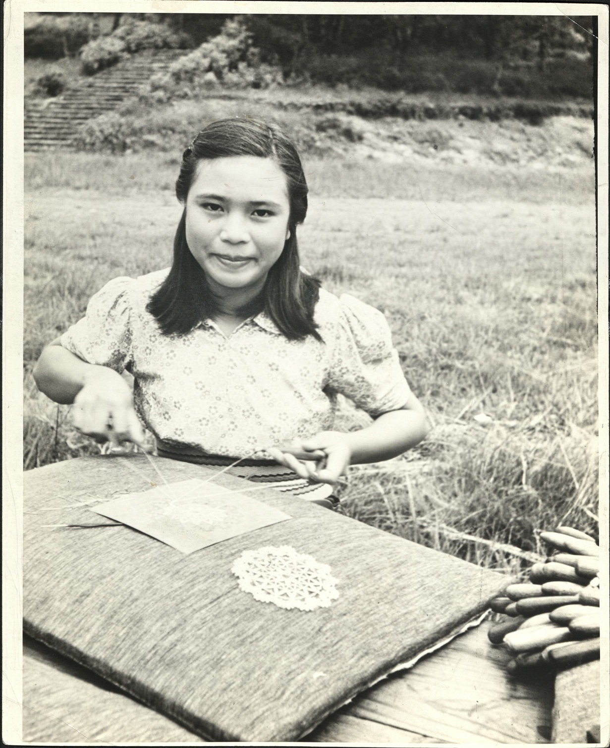 Igorot girl, Mt. Province, P. I. She is a student at the Mission School and is making Belgium point lace.