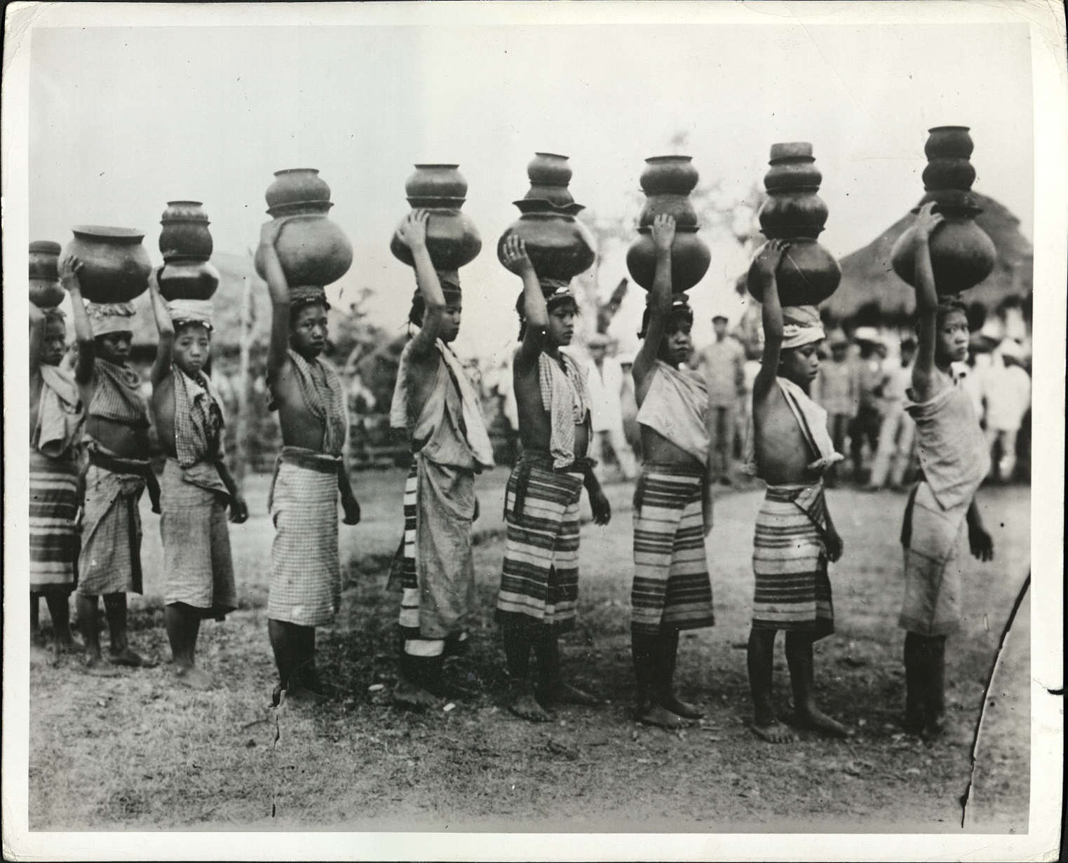 7. PHILIPPINES: Young Philippine girls demonstrate their skill in carrying pottery jugs on their heads.  E – 276.