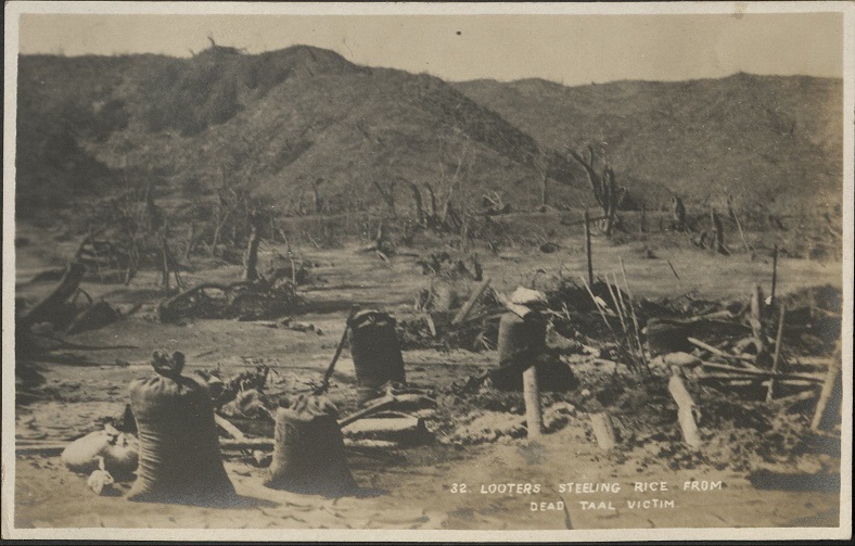32. Looters steeling [stealing] rice from dead Taal victim.