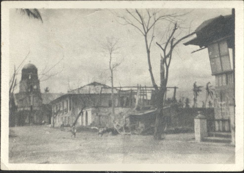[Illegible – Partially-destroyed building and denuded trees].