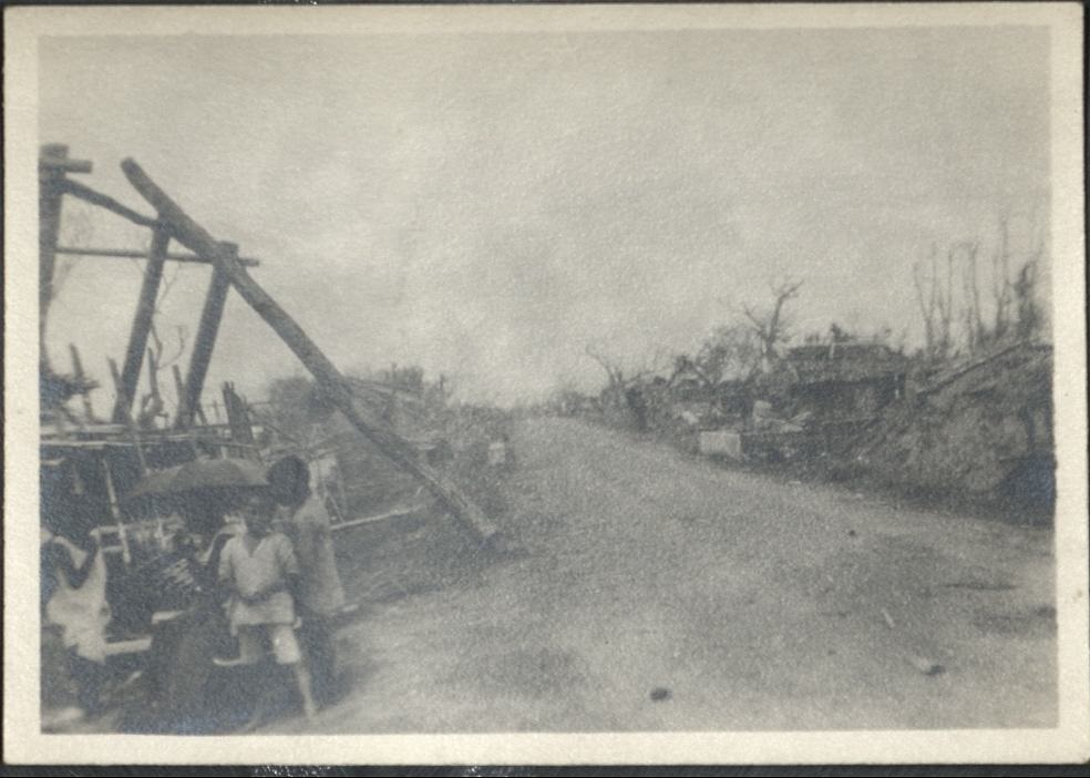[Untitled – Partially-destroyed building frame and denuded trees].