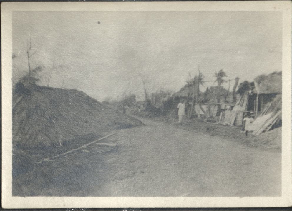 [Untitled – A thatched roof blown off a house now lies in the street].