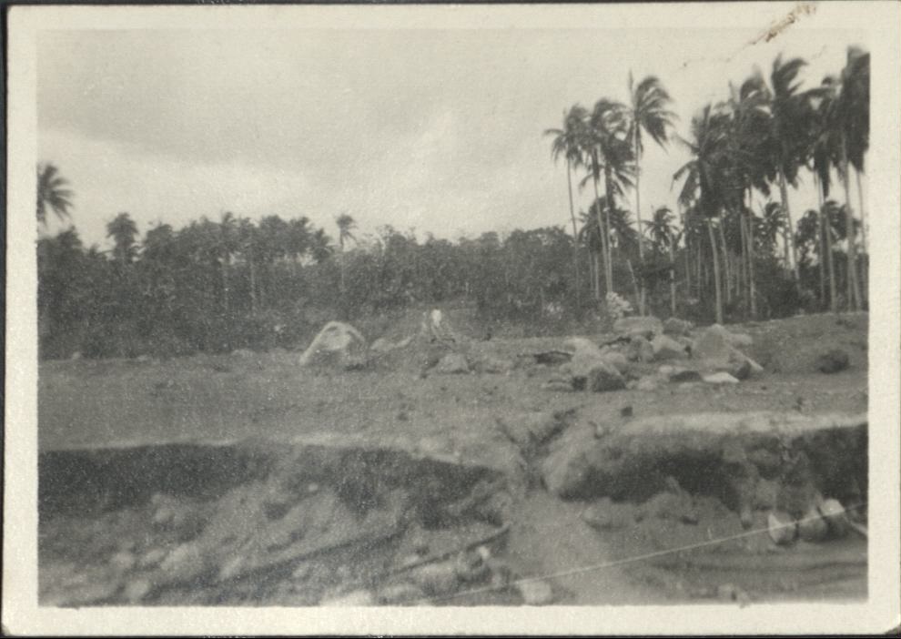 [Untitled – Man inspects railroad tracks covered with dirt and rocks after a flood or landslide].
