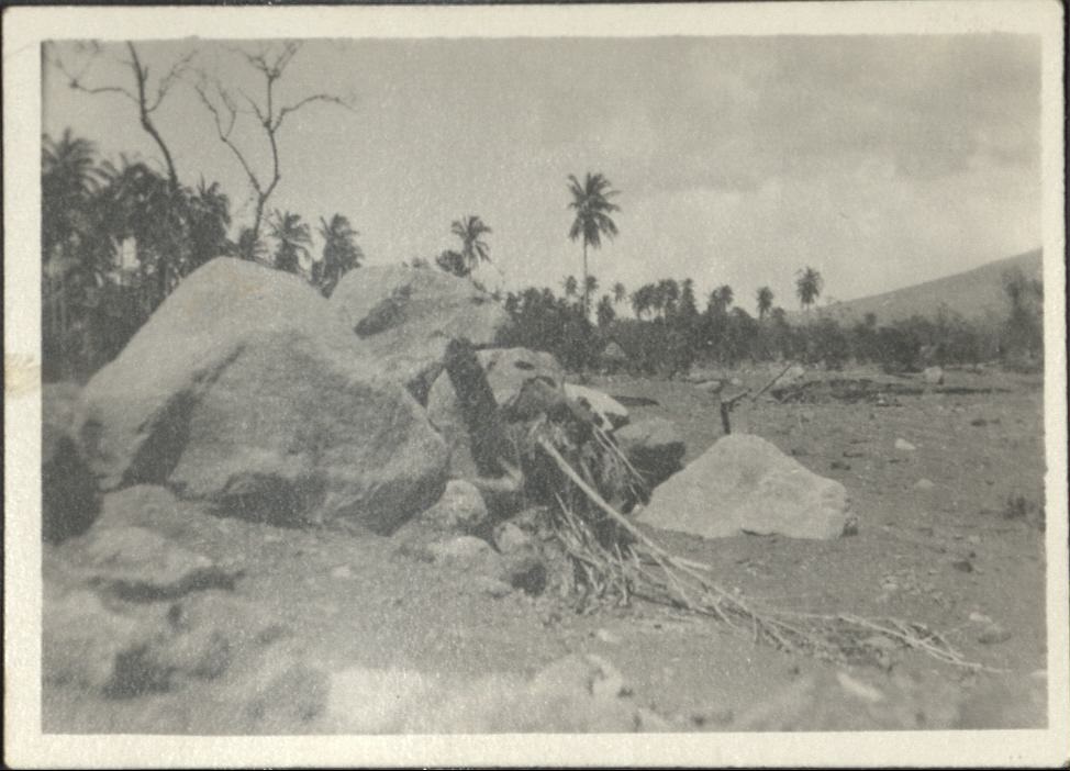 [Untitled – Railroad tracks covered with dirt and big boulders after a flood or landslide].
