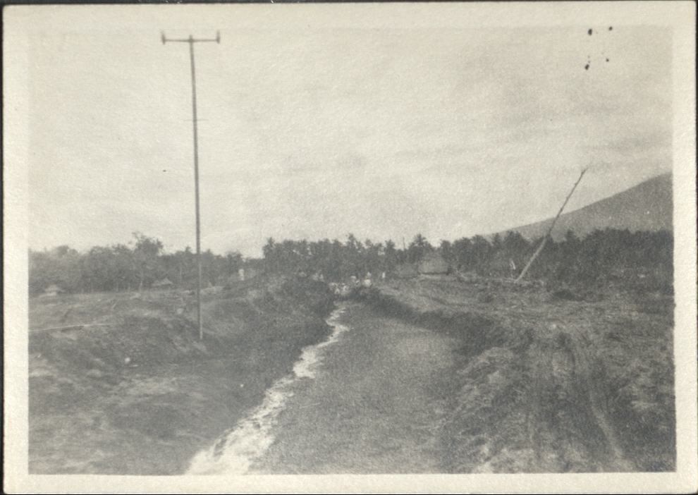 [Untitled – Men excavate railroad tracks covered with dirt and rocks after a flood or landslide].