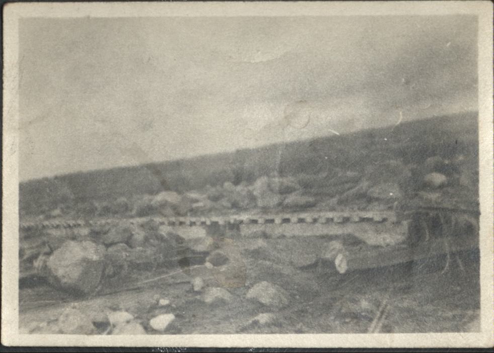 [Untitled – Washed-out railroad tracks covered with tree, dirt and rocks after a flood or landslide].