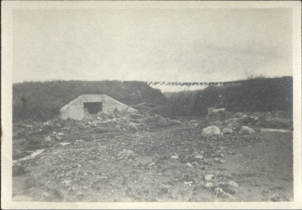 [Untitled – Washed-out bridge and  railroad tracks covered with dirt and rocks after a flood or landslide].
