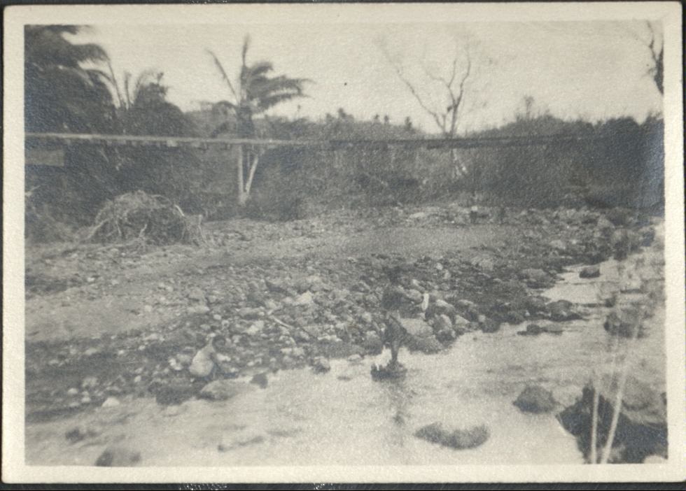 [Untitled – Washed-out bridge and  railroad tracks hanging in mid-air after a flood or landslide].