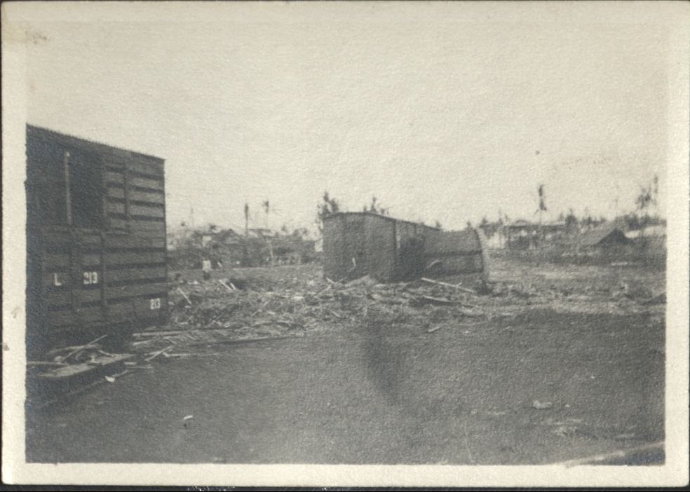 [Untitled – Railroad cars damaged and toppled by flood or landslide debris].