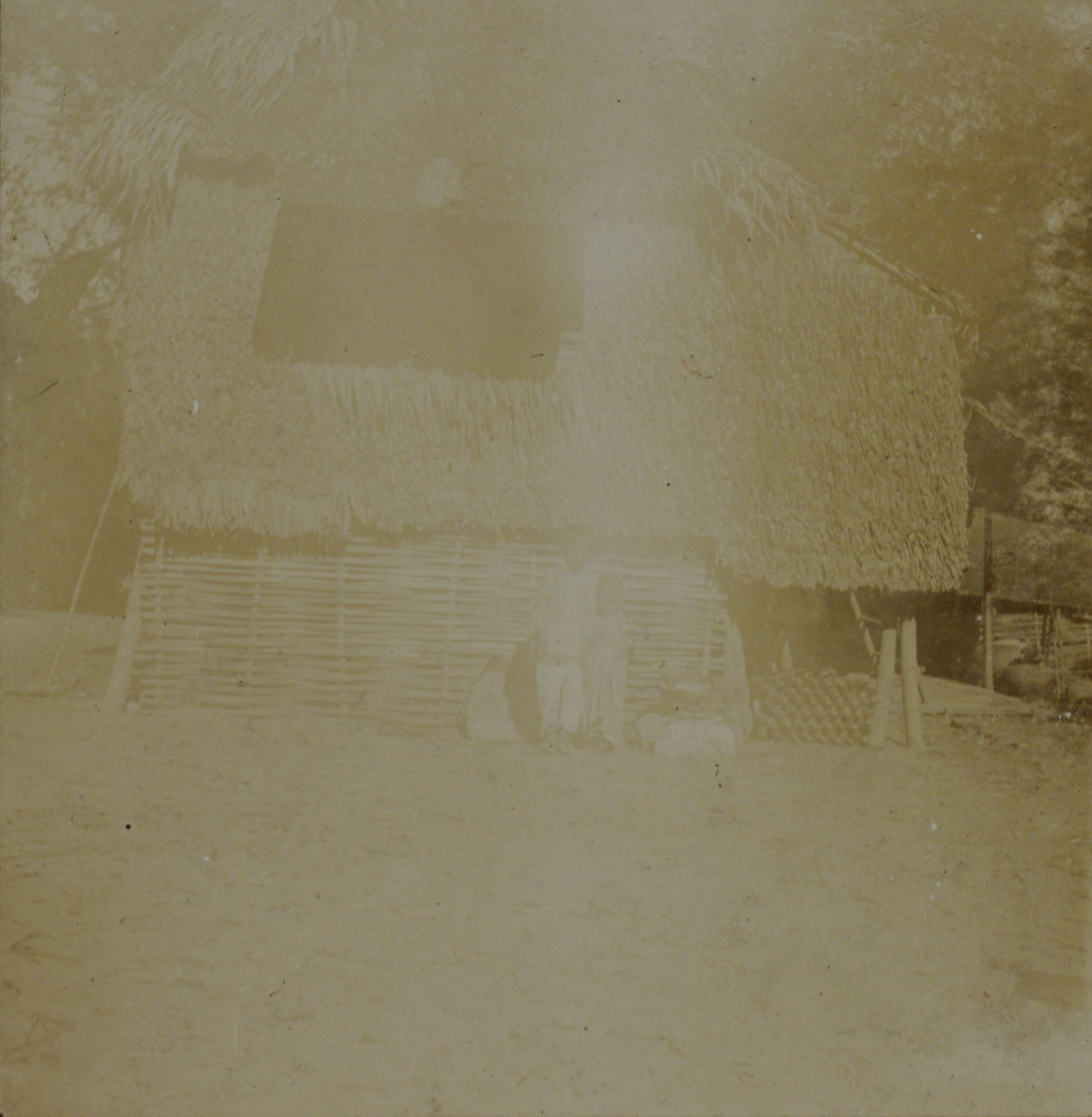 [Untitled – Filipino family outside a nipa hut].