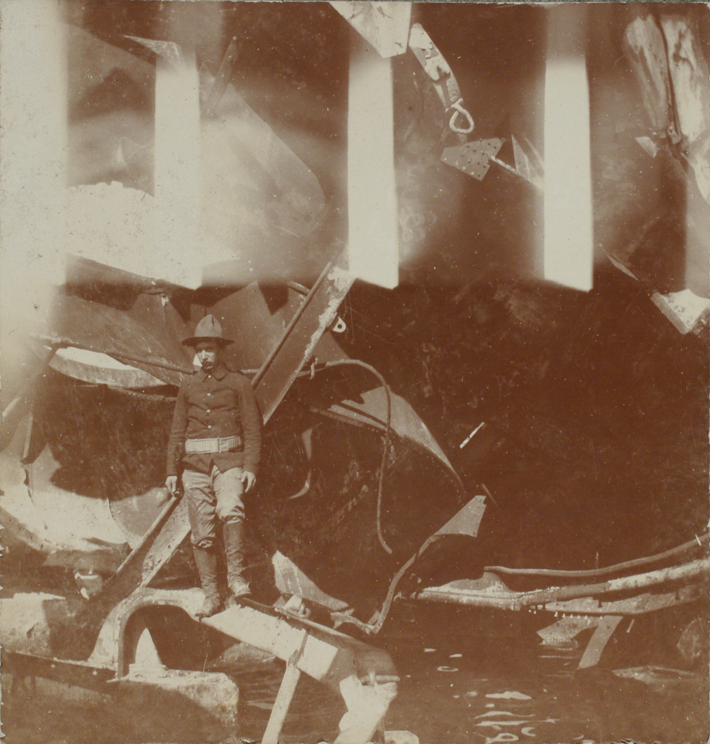 [Untitled – U.S. soldier standing on wreckage of a sunken Spanish warship?].