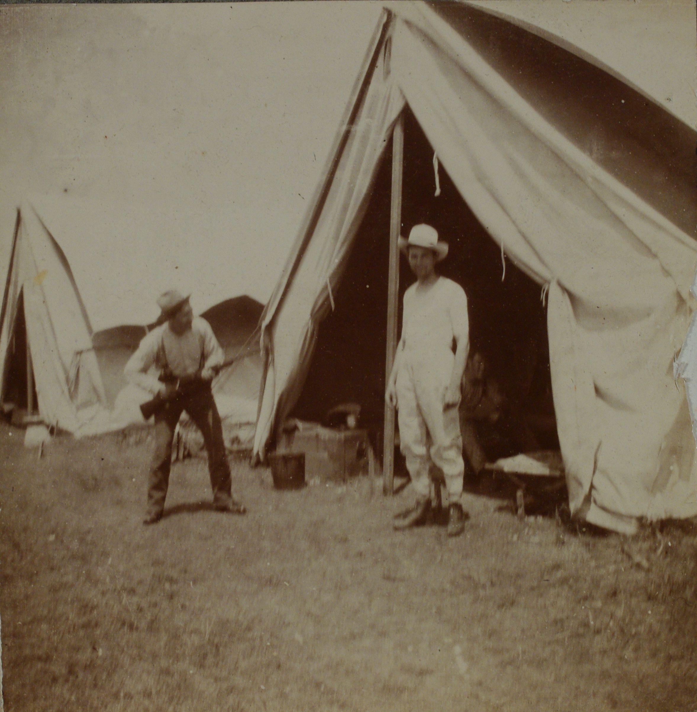[Untitled – Play-acting outside a U.S. Army tent].