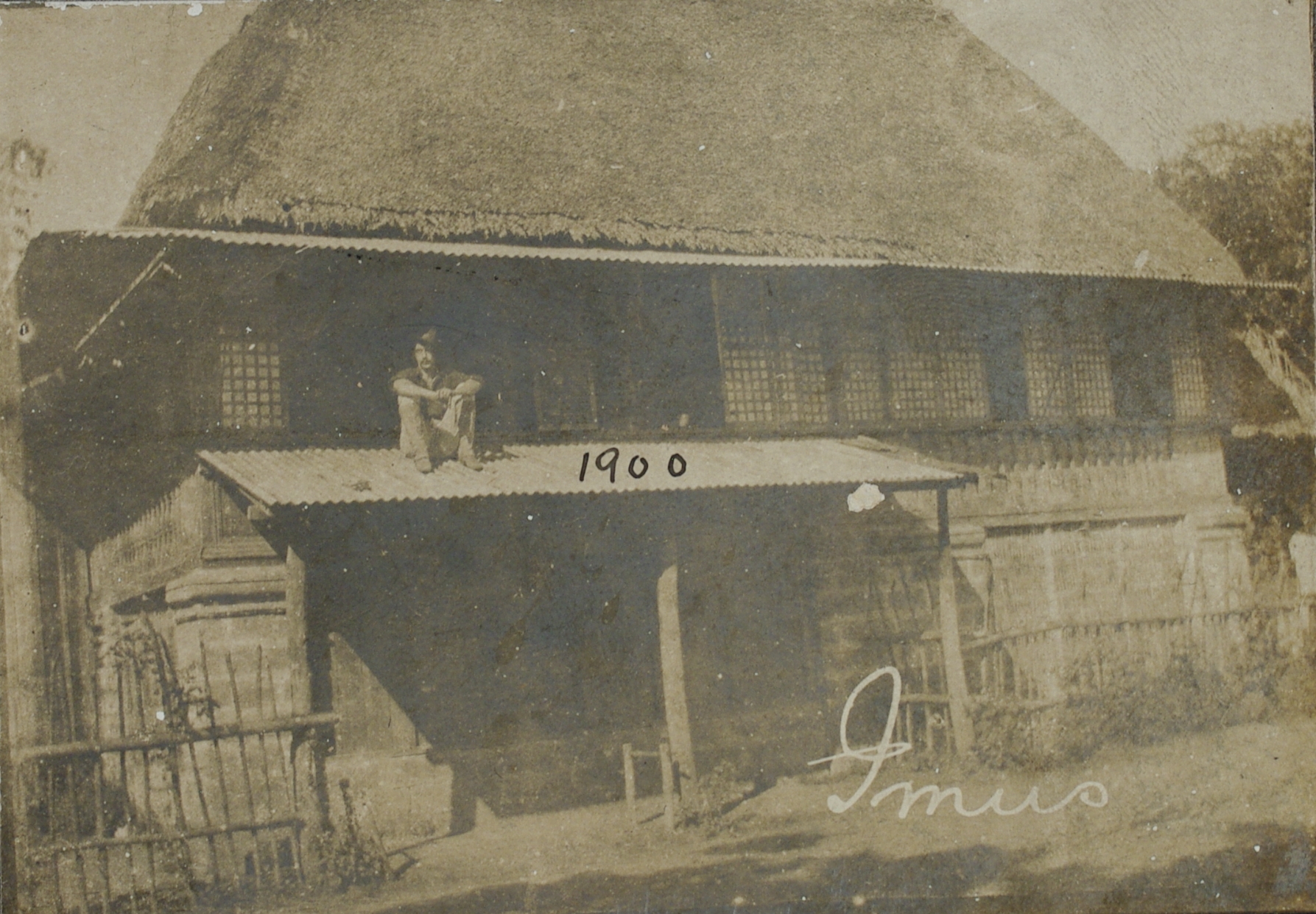 Imus [Cavite], 1900 [Soldier sitting on a corrugated roof].